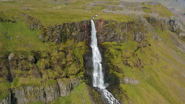 Aerial Drone Footage of Bjarnarfoss Waterfall with Its Green Cliffs in Western Iceland