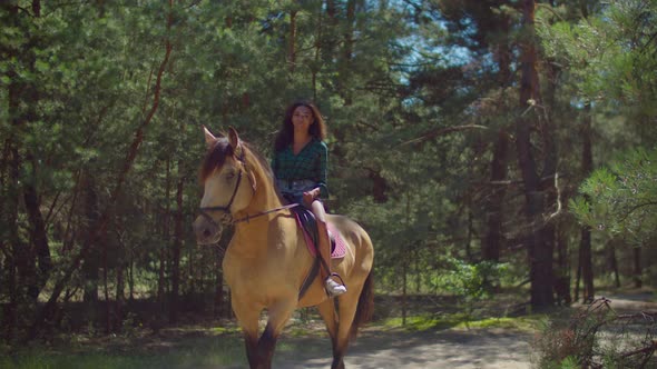 Positive Black Female Riding on Horseback in Wood