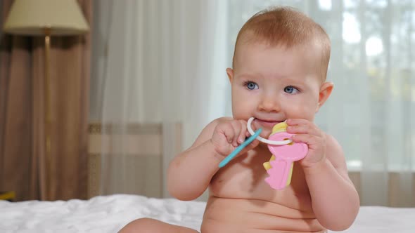 Welcoming Mortgage Services. Lovely Baby Girl Playing with Toy Keys at Home in Bedroom Looking at