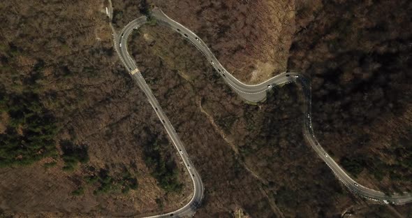 Aerial Autumn Road From Above View of Cars on a Zig Zag Road. Season Forest Road Landscape. Mountain