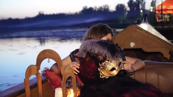 Beautiful Woman With Carnival Mask Riding on Gondola.