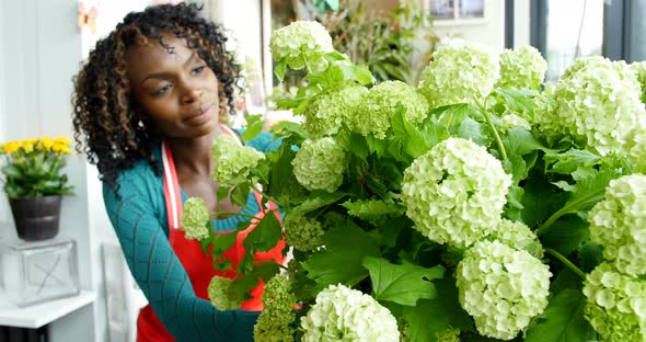 Female florist arranging flower in flower shop