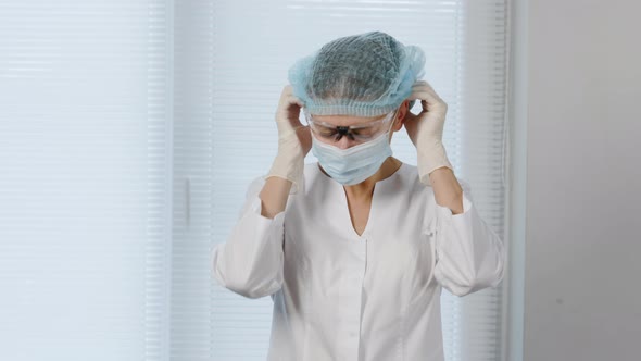 Medical Doctor Woman In Special Medical Clothing In A Protective Mask On Face