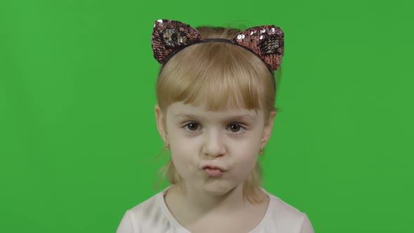 Girl in Cat Headband Looks at Camera and Smile