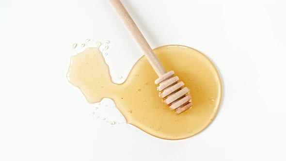 Rotation of the Composition with Fresh Honey on a White Background Top View