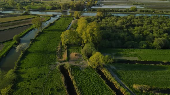 Aerial view of a swamp at sunset, near Clairmarais France. There is a river in the distance, fields