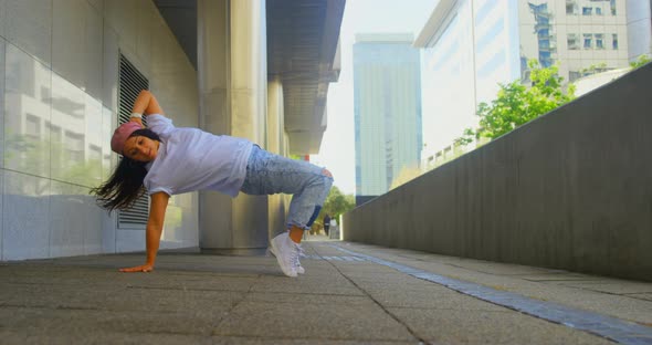 Young female dancer performing dance under bridge 4k