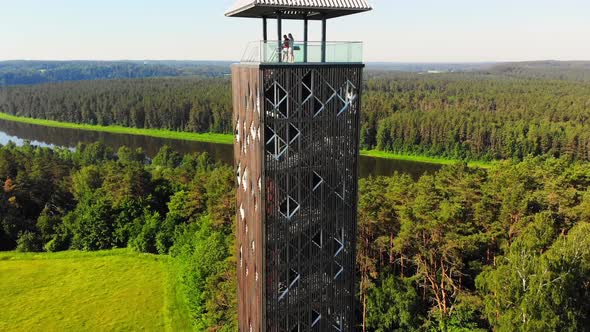 Couple Stands On Famous Observation Tower Landmark In Lithuania