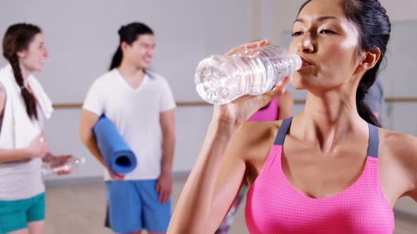 Portrait of woman drinking water