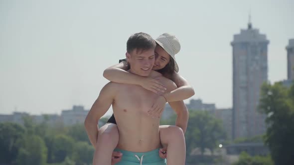 Happy Young Couple Having Fun on the Beach