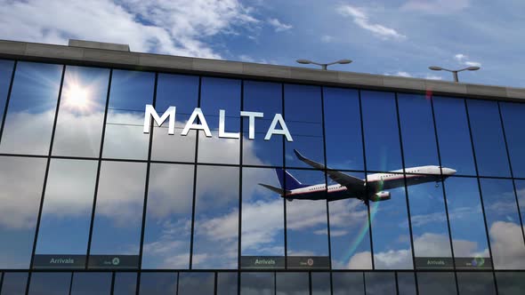 Airplane landing at Malta airport mirrored in terminal