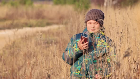 The Boy Looks at the Camera and Talk Via Video Call in the Smartphone