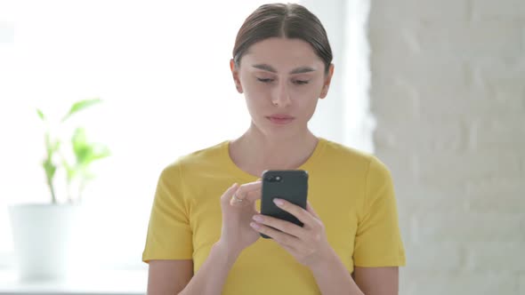 Portrait of Woman Reacting to Loss on Smartphone