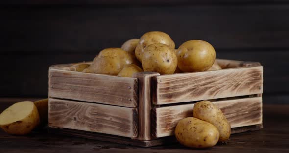 Fresh Potatoes in a Wooden Box with Cool Steam. 