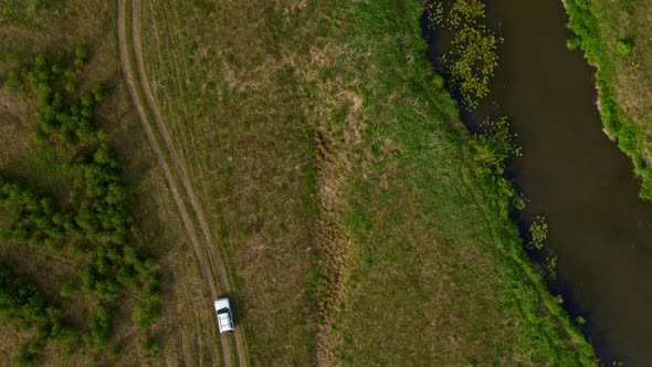 Top View of the Car Driving Along the River Bank