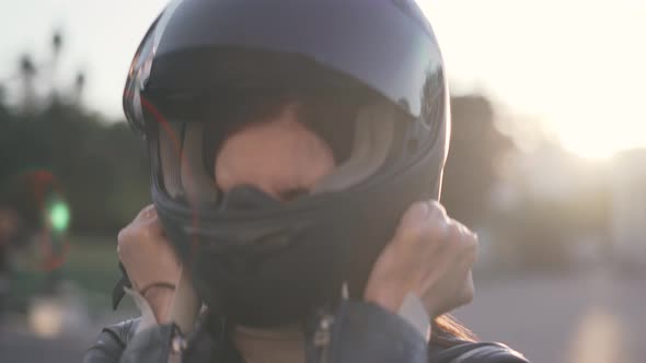 Beautiful Young Redhaired Woman Motorcyclist with Black Motorcycle Helmet