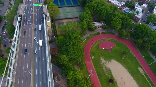 People Run on a Track Under a NYC Bridge