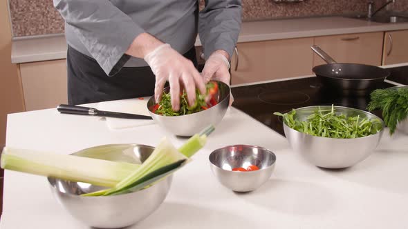 Cooking Concept. Young Man Cuts Vegetables in the Kitchen