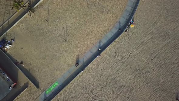 Venice beach California Drone shot panning out with a rotation over bike trail.