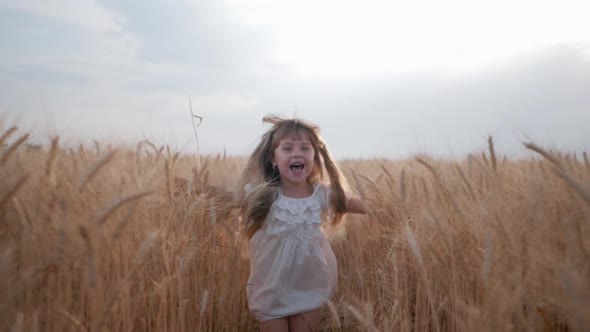 Funny Childhood, Sweet Small Girl with Beautiful Blue Eyes in White Clothes Runs with Arms Spread