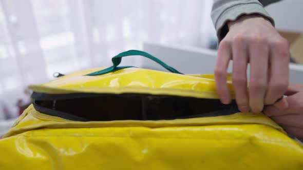 Closeup Male Hands Zipping Yellow Insulated Food Delivery Bag