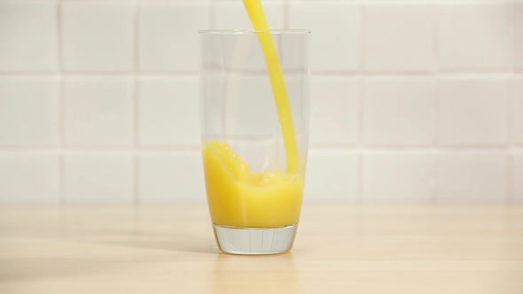 Pouring orange juice into a glass