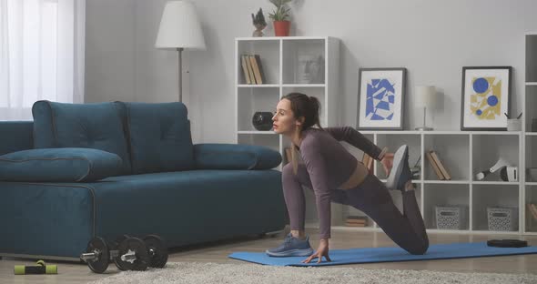 Woman Is Doing Exercise for Stretching Legs Muscles Training at Home Caring About Beauty of Body