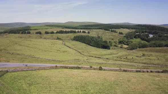 Aerial view of Dartmoor National Park farmland. The fields have stones wall for separation, and a ro