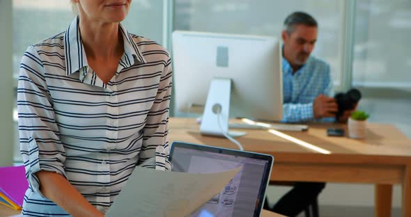 Confident female executive sitting at her desk