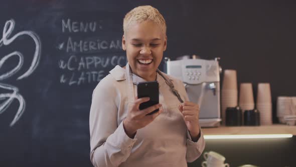 Female Coffeeshop Worker Getting Good News