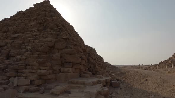 Close Up View Beside Base Of The Queen’s Pyramids Of Giza With Slow Pan Right