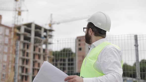 Portrait of a Successful Young Engineer or Architect Wearing a White Helmet