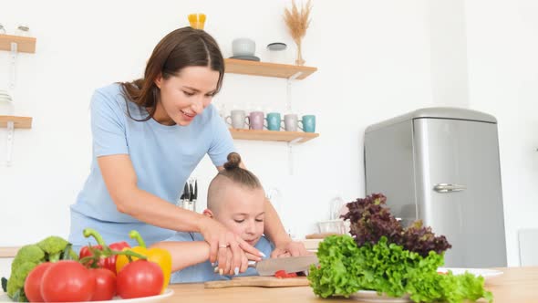 Young Beautiful Mother Teaches Her Son to Cook a Healthy Breakfast of Fresh Vegetables