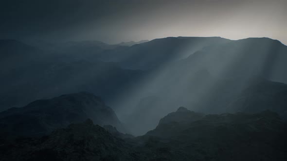 Black Rocky Mountain Silhouette in Deep Fog