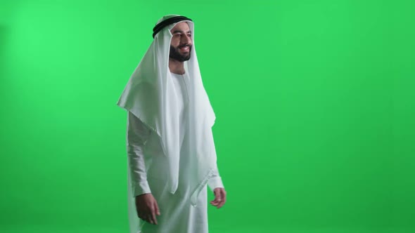 Arab Man in a White Robe on the Green Background Walking Cheerful Man Wearing Kandura Chroma Key