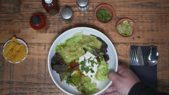 Overhead of Traditional Mexican Salad in the Bowl Placed on Served Wooden Table