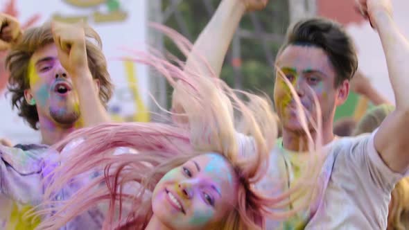 Active Young People Dancing and Looking to Camera, Having Fun at Color Festival