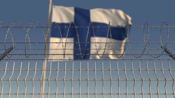 Barbed Wire Against Waving Flag of Finland