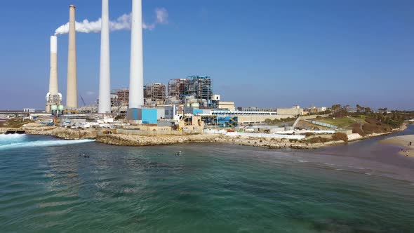 Hadera Park, Orot Rabin Power plant aerial pull out shot over Mediterranean sea , river mouth and be