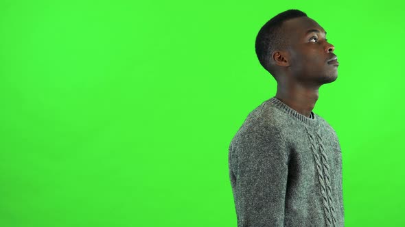 A Young Black Man Walks Back and Forth and Thinks About Something - Green Screen Studio