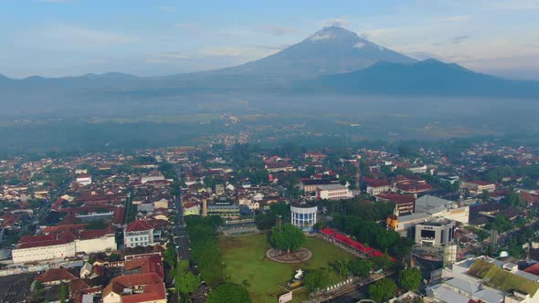 Aerial panorama of downtown Magelang Indonesia and Mount Sumbing and Merbabu