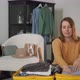 A Young Woman is Packing Her Suitcase - VideoHive Item for Sale