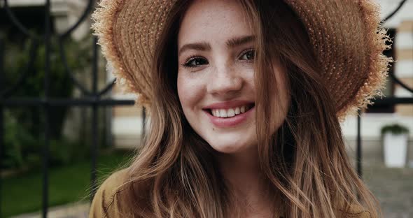 Portrait of Pretty Young Girl with Freckles on Face, wears Straw Hat.