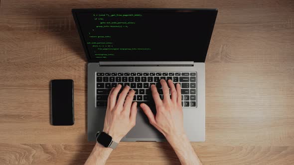 Closeup a Man Hands are Typing Commands of a Laptop Keyboard