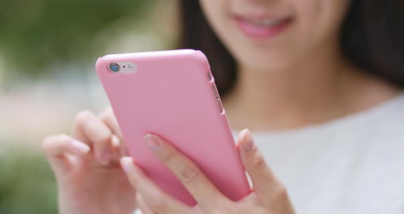 Woman sending sms on cellphone at outdoor