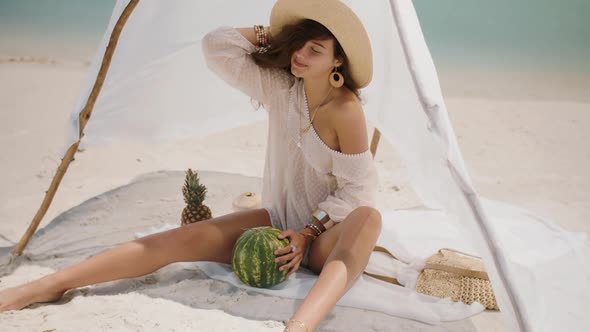 Woman on the Tropical Beach Eating Watermelon