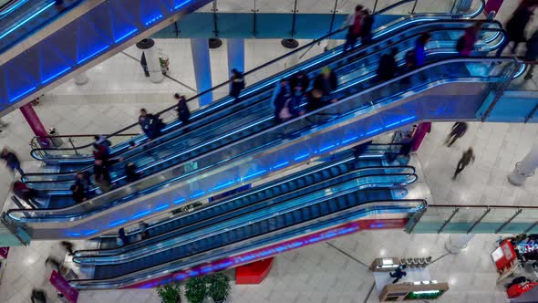 People Moving Over Escalators