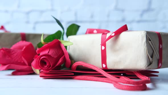 Gift Box Rose Flower and Shopping Bag on Table