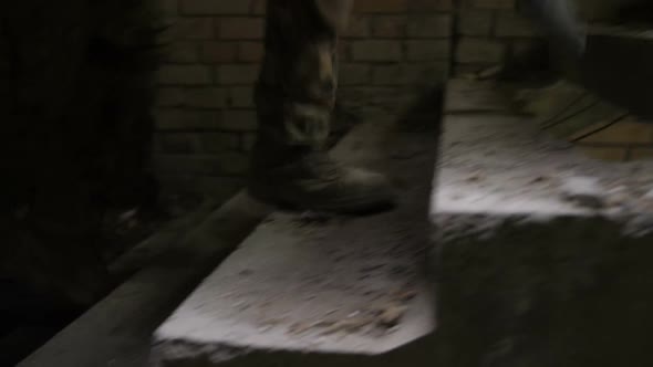 Soldiers Legs in Army Boots Climbing Up Staircase alt