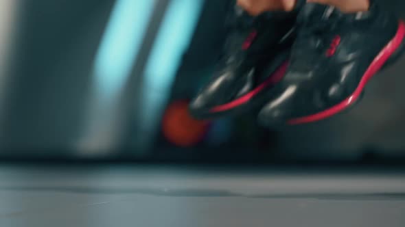 A Female Feet in Sneakers Jumping with a Skipping Rope. Workout with Elements of Cardio. Person